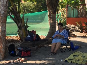 People sitting on chair against plants