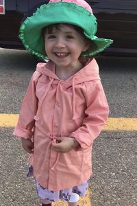 Portrait of smiling girl standing outdoors