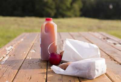 Close-up of food and drink on picnic table at park