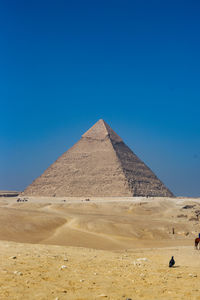 View of desert against clear blue sky