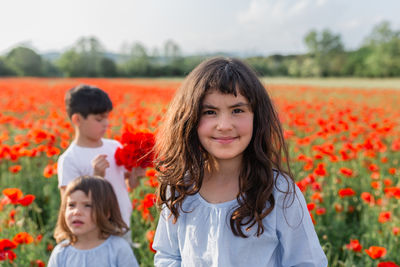 Portrait of young woman standing on field