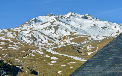 Low season half snowy mountains at a ski resort , pyrenees, spain