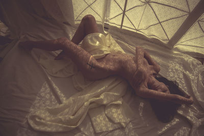 High angle view of baby lying on bed at home