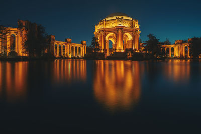 Reflection of building in lake at night