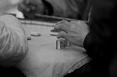 Cropped hands playing with gambling chips on table