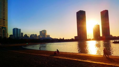 City at waterfront during sunset