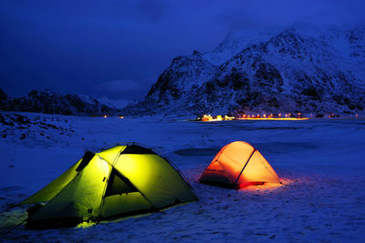 Scenic view of snowcapped mountains against sky at night