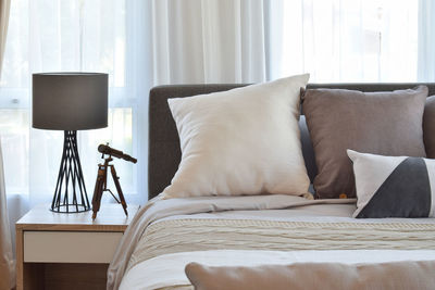 View of electric lamp on bed at home