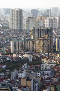 High angle view of buildings in city against sky