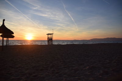 Scenic view of beach against sky during sunset