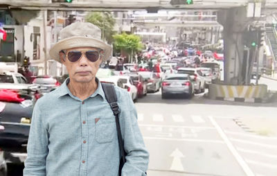 Portrait of man standing in car