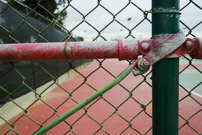 Close-up of fence at tennis court