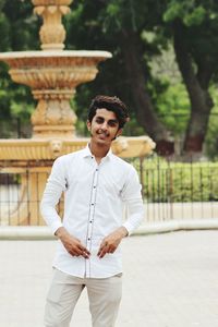 Portrait of young man standing in city