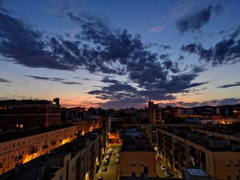 High angle view of illuminated buildings against sky at sunset