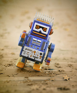 Close-up of toy toys on beach