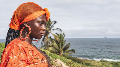 Ghana woman looks out over the coast in takoradi, located in ghana, west africa.
