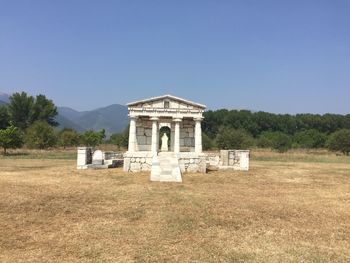 Historic built structure on field against clear sky