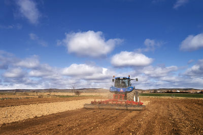 Tractor modern , farm equipment woriking in field