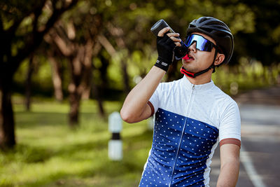Full length of boy standing against plants