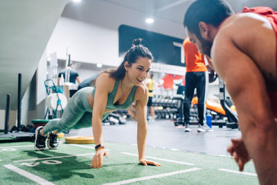 Side view of woman exercising in gym