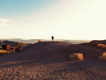 Woman with arms raised against sky