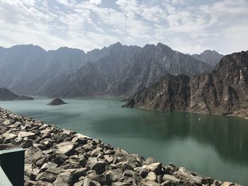 Scenic view of lake and mountains against sky