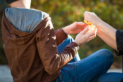 Midsection of man eating ice cream