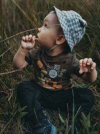 Full length of cute boy lying on land