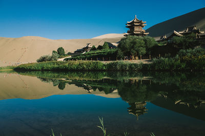 Scenic view of crescent lake against sky