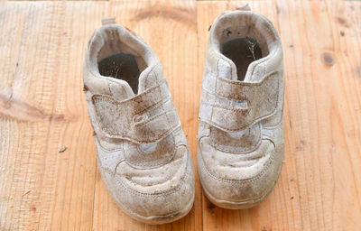 Close-up of old shoes on wooden table