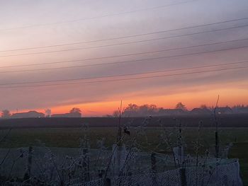 Scenic view of field against sky during sunset
