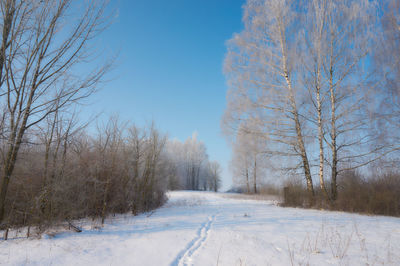 Snow covered landscape against clear sky