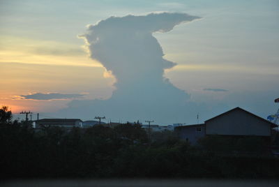 Smoke emitting from chimney against sky at sunset