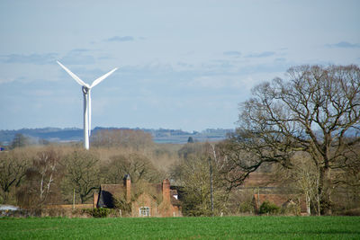 Windmill on field against sky