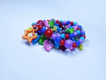 High angle view of multi colored candies against white background