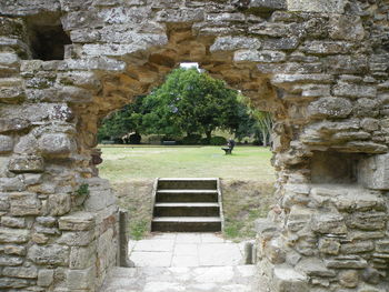 High angle view of steps by stone wall against sky