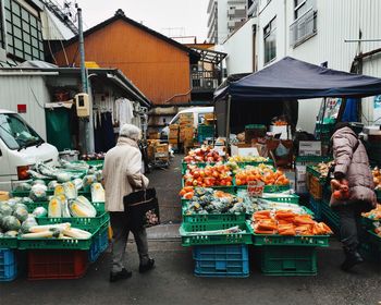 Rear view of person walking in market