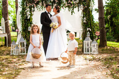 Rear view of bride holding bouquet