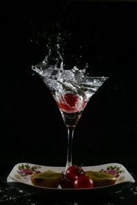 Close-up of drink on table against black background