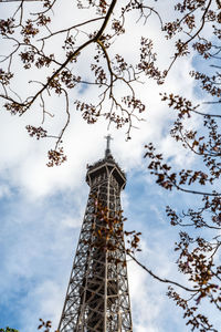 Low angle view of tower against cloudy sky