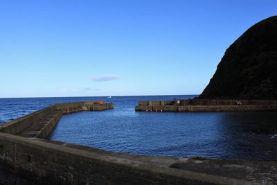 Scenic view of sea against clear blue sky