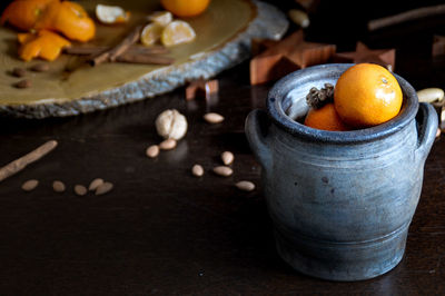 High angle view of fruits and nuts in a jar on table to show autumn season