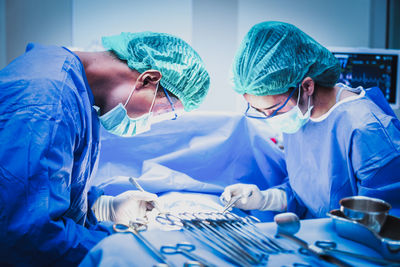 Surgeons operating patient in hospital