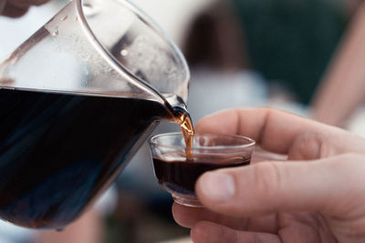 Close-up of hand holding coffee cup