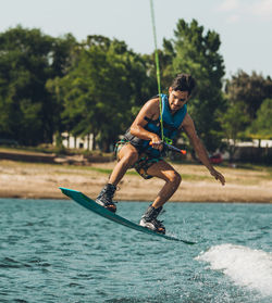 Young man jumping in swimming pool