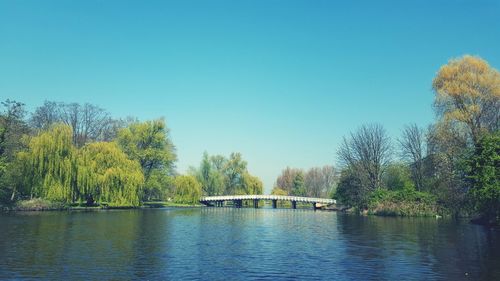 Scenic view of river against clear blue sky