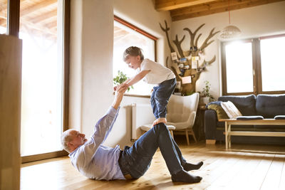 Grandfather and grandson having fun at home