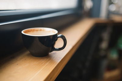 Close-up of coffee cup on table