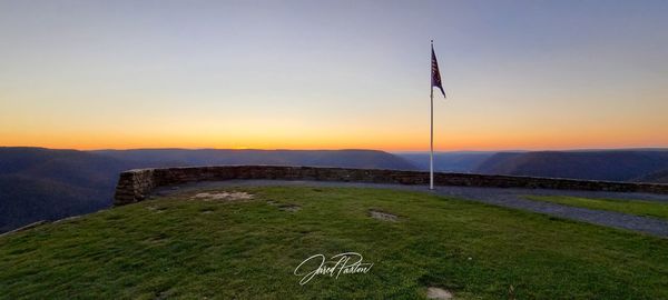 Scenic view of field against sky during sunset