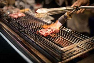 High angle view of meat on barbecue grill